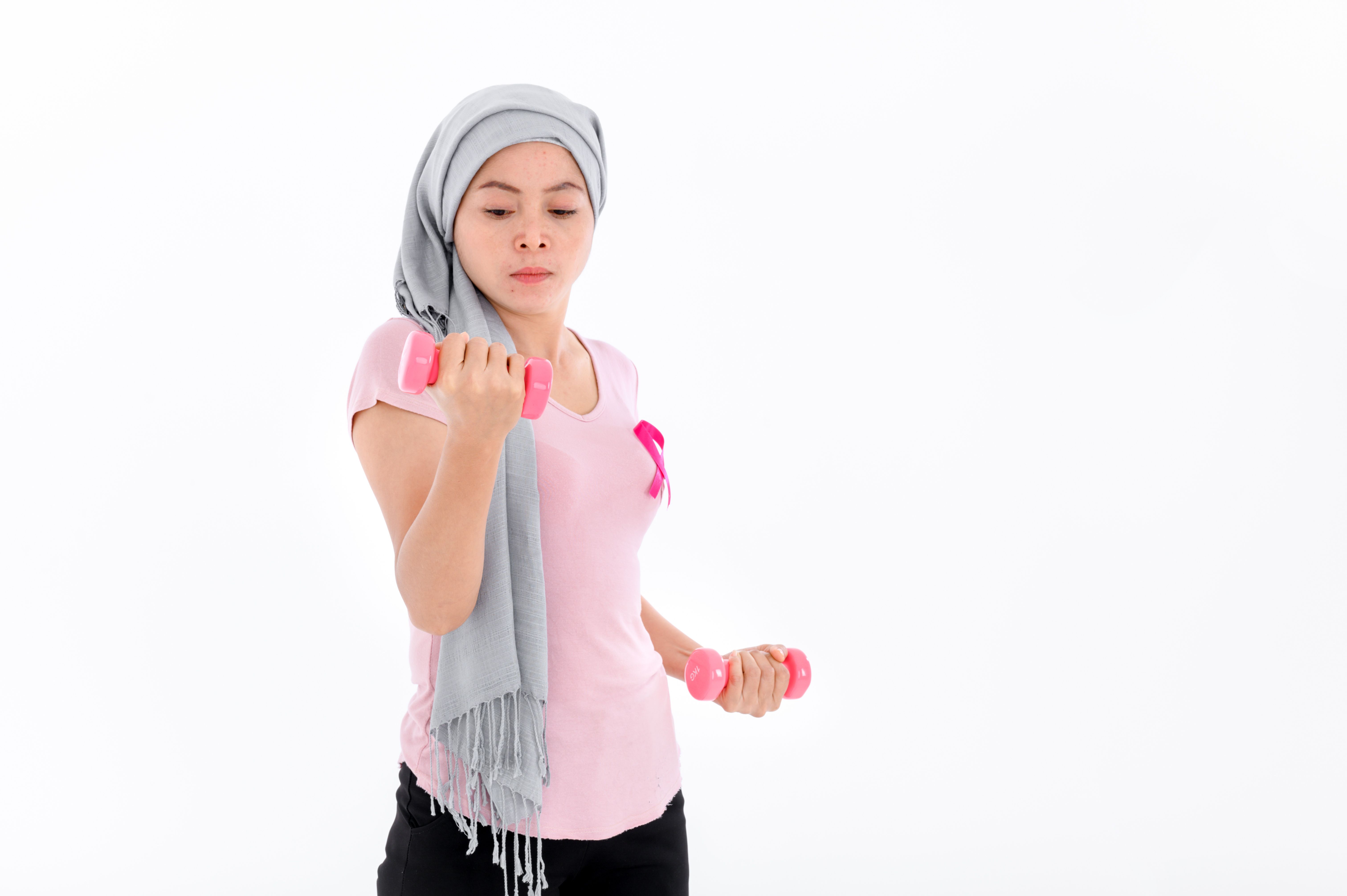 Woman exercising with dumbbells | Image Credit: SEVENNINE_79 - stock.adobe.com