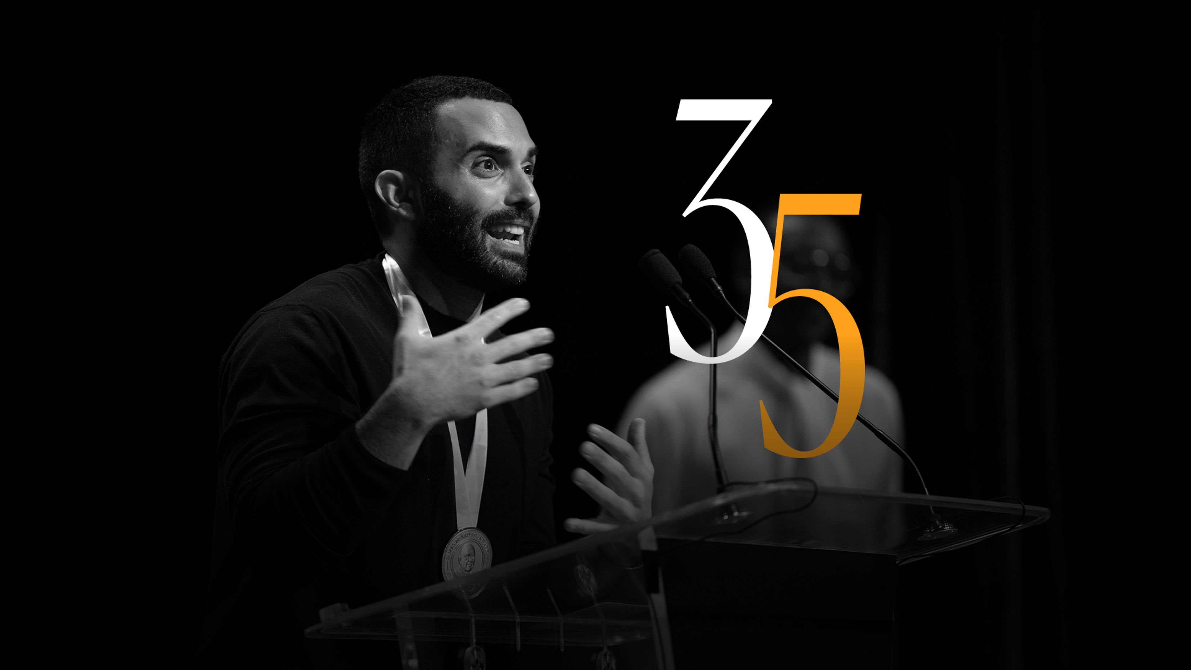 Large 35 logo with Andy Baraghani accepting a JBF Media Award in black and white