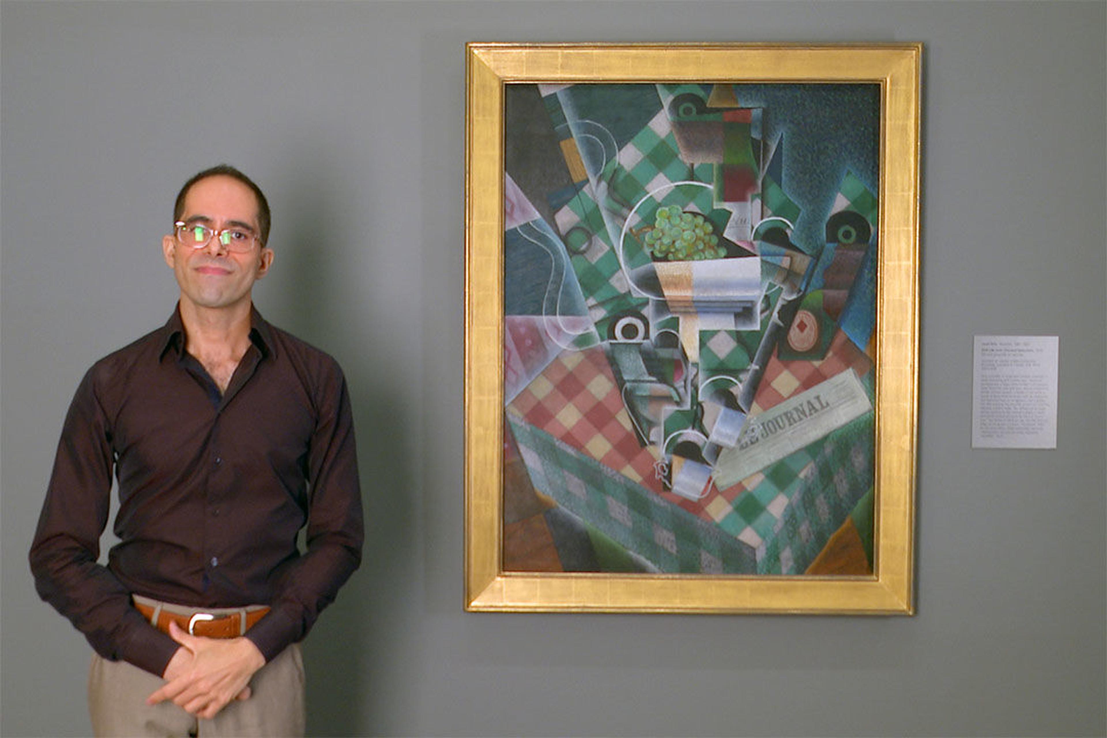 Art Historian and Met educator Emmanuel von Schack standing beside Juan Gris's cubist painting, "Still Life with Checked Tablecloth"