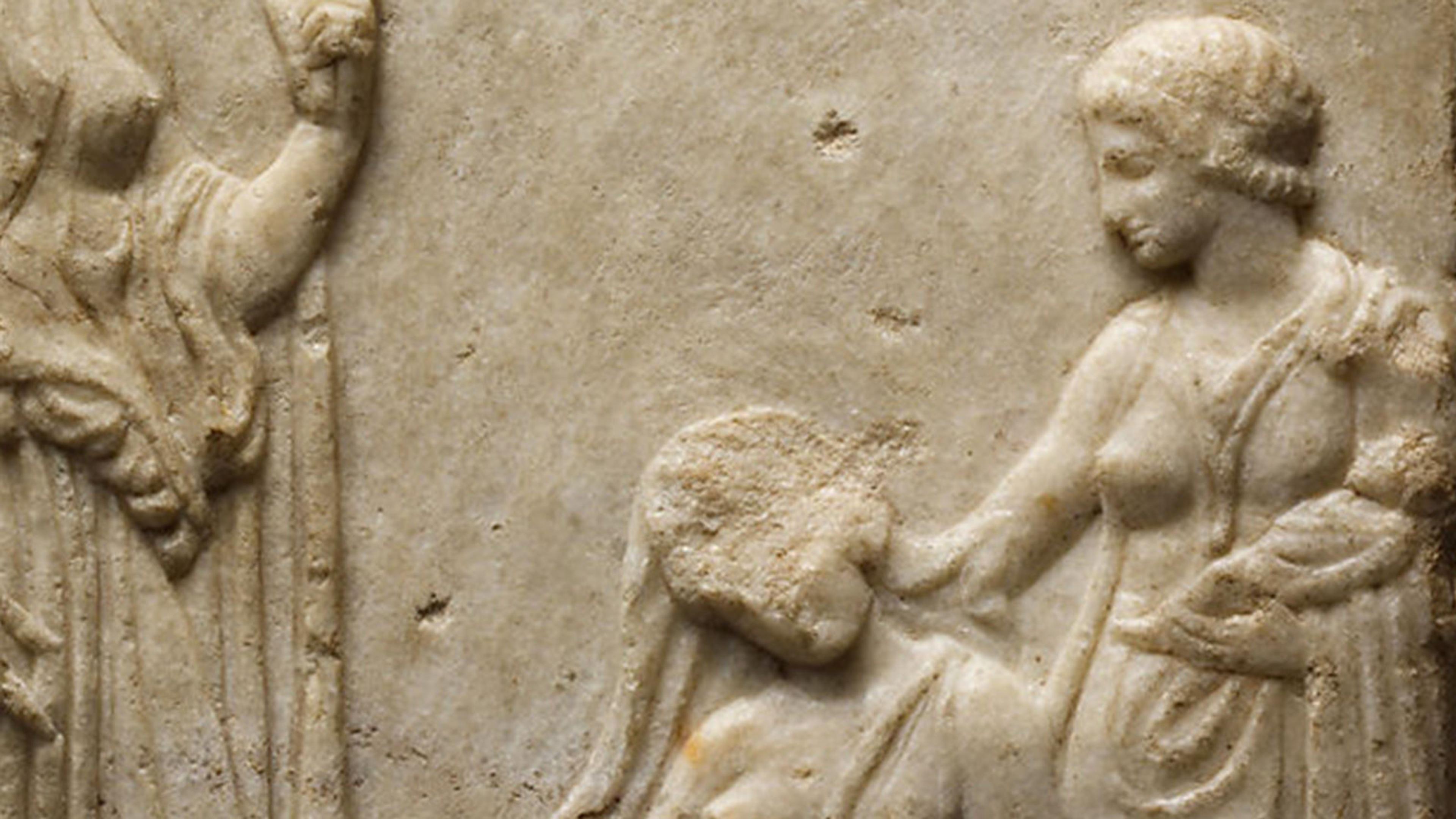 Detail of a woman holding a baby in her arms while resting her elbow against a sitting woman who appears exhausted