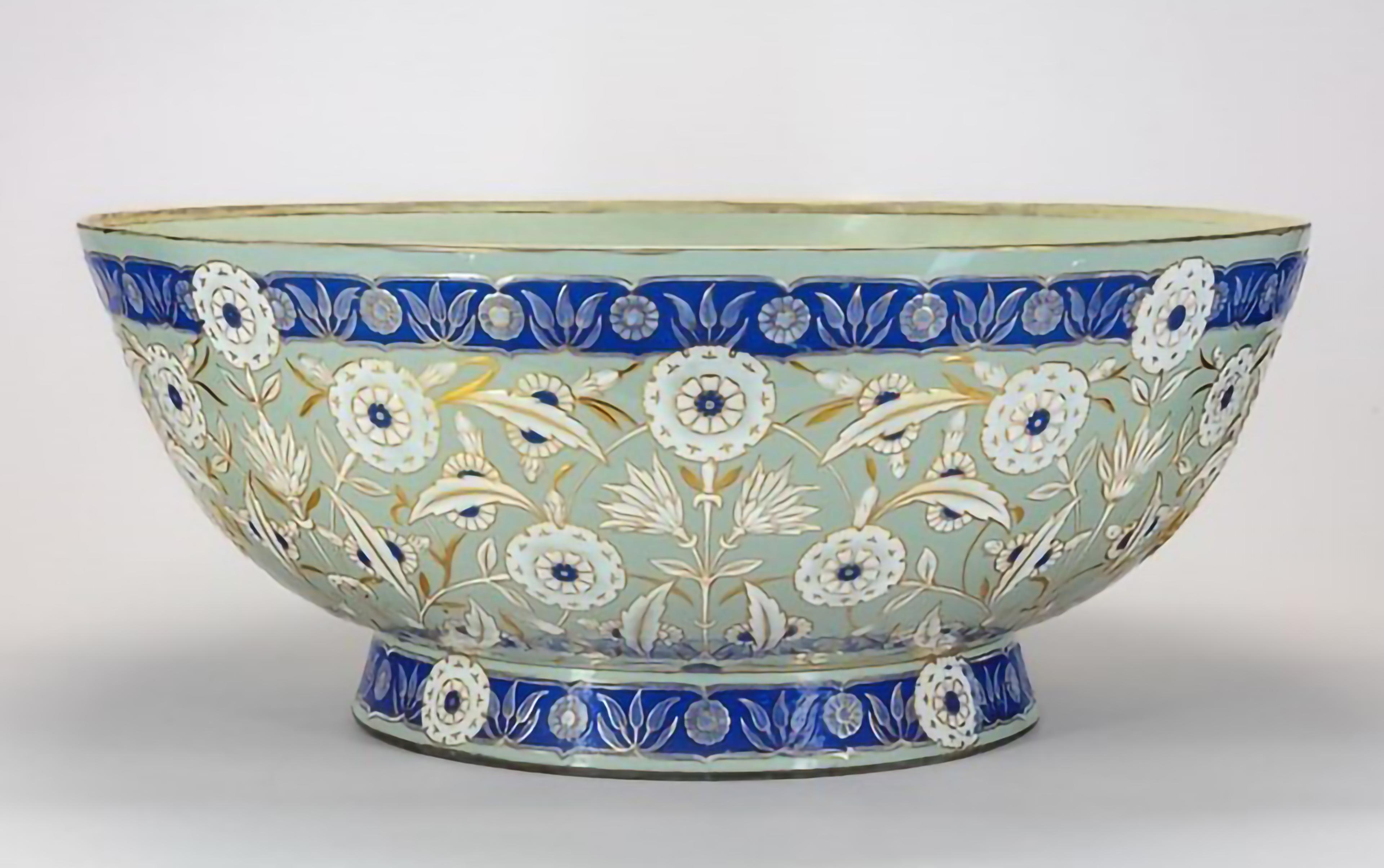 Green, blue, and white ceramic bowl with floral motifs