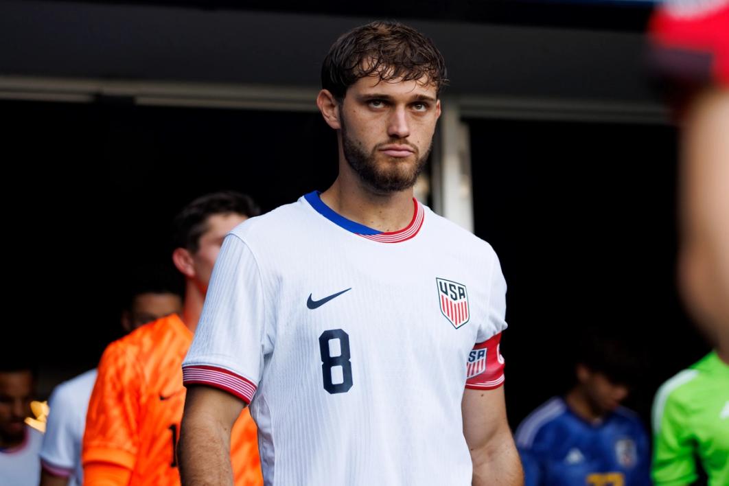 USA Captain Tanner Tessmann looks up as he walks out of a tunnel before a match